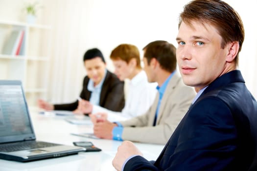Portrait of businessman looking at camera during business conference