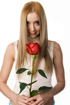Portrait of elegant long-haired lady with beautiful rose looking at camera