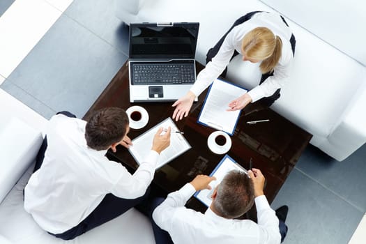Photo of successful employees discussing business plan at meeting