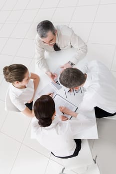Above view of friendly workteam discussing new ideas at meeting