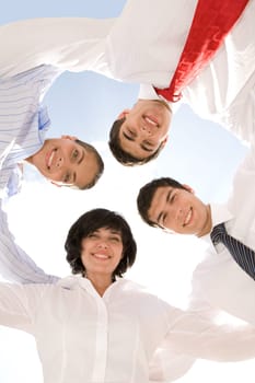 Photo of successful business team embracing each other