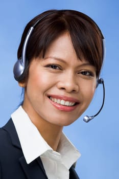 Image of successful professional in headset looking at camera with smile