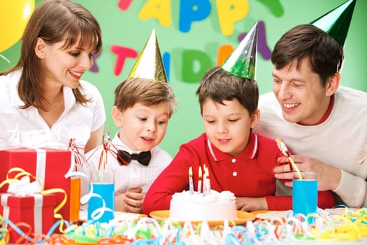 Portrait of family looking at holiday cake