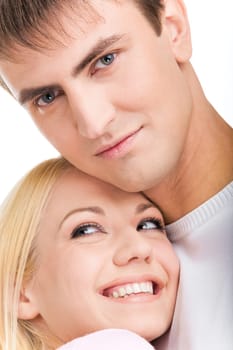 Young man looking at camera with pretty woman laughing close to him