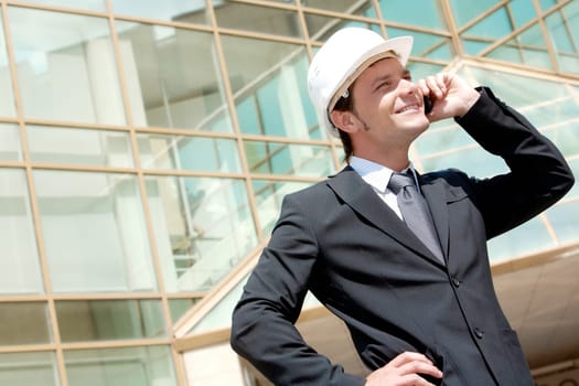 Portrait of confident smiling foreman calling by the phone
