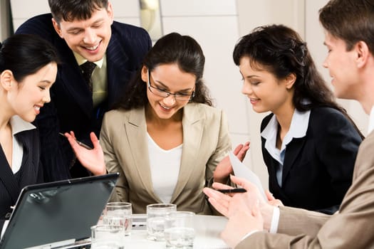 Image of successful businesswoman with four colleagues looking at plan near by