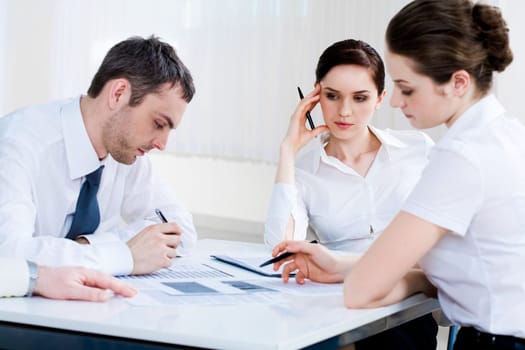 Photo of confident co-workers planning new project at briefing