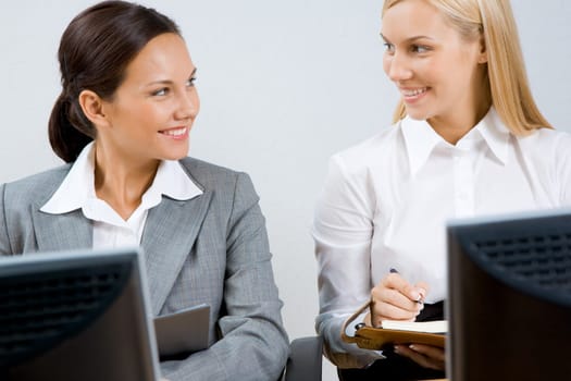 Portrait of busy women discussing new working plan at meeting
