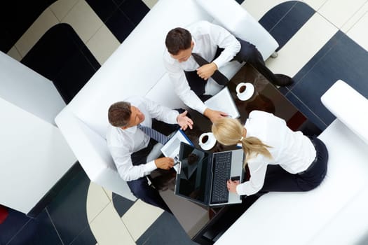 Photo of successful employees discussing business plan at meeting