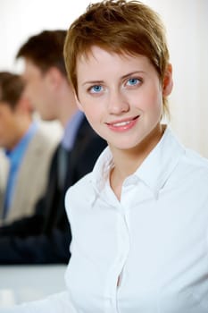 Image of pretty female looking at camera in working environment