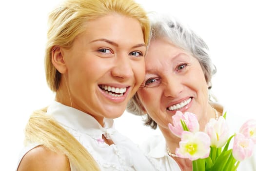 Portrait of happy woman and her senior mother looking at camera