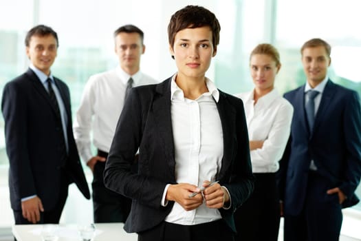Portrait of female manager against her colleagues