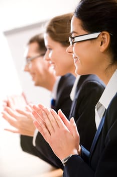 Vertical image of row of successful business people applauding somebody