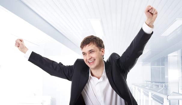 Portrait of a joyful man with raised hands