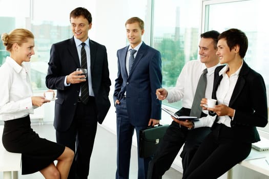 Five business colleagues communicating at break