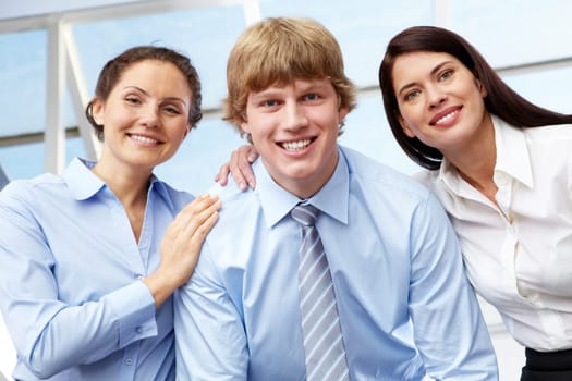 Portrait of friendly three business people looking at camera