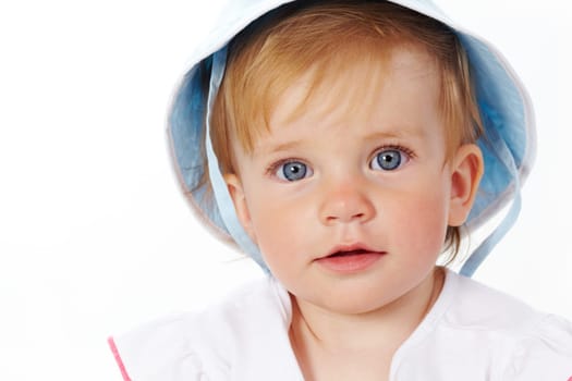 Portrait of cute child looking at camera over white background