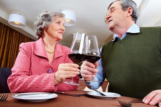 Image of couple looking at each other and drinking for love