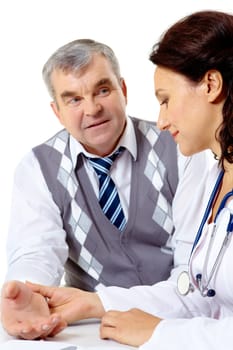 Portrait of friendly therapist checking patient pulse during medical consultation