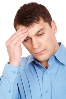Portrait of young man touching his forehead with tired expression