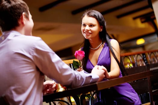 Portrait of happy couple holding by hands and looking at each other
