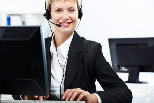 Secretary with headset looking at camera and smiling