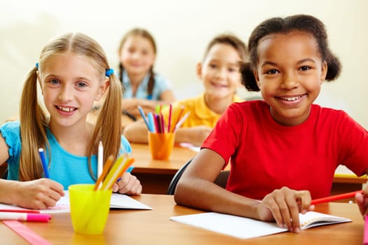 Portrait of lovely girls looking at camera at lesson