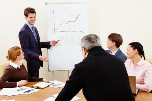 Image of confident man making presentation and interacting with the audience