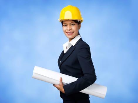 Portrait of confident female worker in helmet holding paper