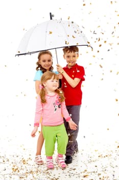 Portrait of smart children under umbrella over confetti falling
