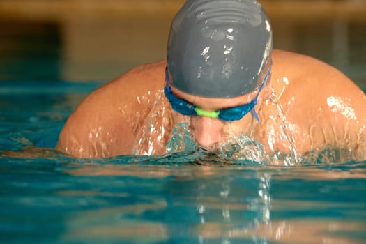 Photo of sportsman swimming during competition
