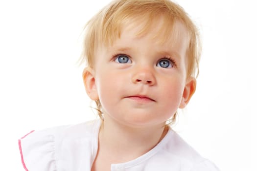 Portrait of curious child looking upwards over white background