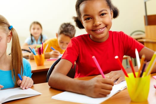 Portrait of lovely girls looking at camera at lesson