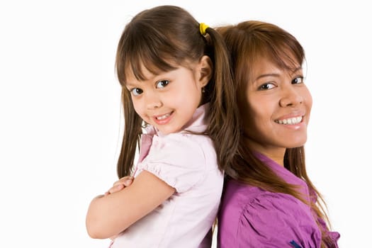 Happy child and her mother looking at camera with smiles on white background