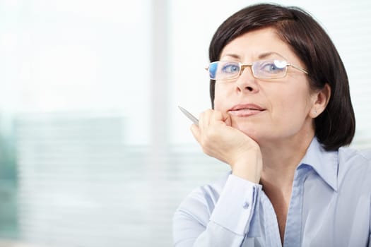Mature businesswoman in eyeglasses looking at camera