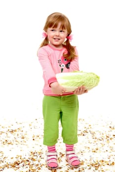 Portrait of happy girl holding Chinese cabbage