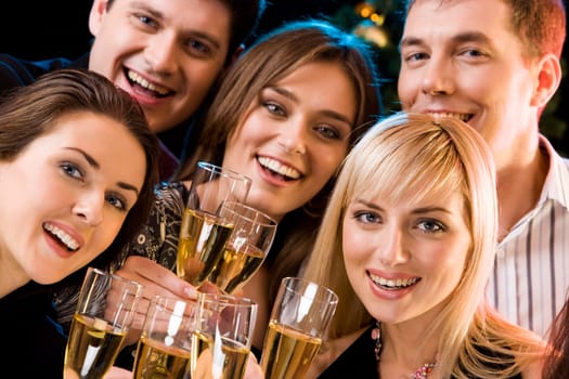 Portrait of smiling people holding cocktails and looking at camera