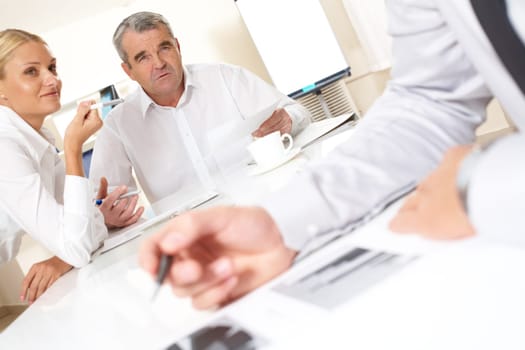 Portrait of confident boss looking at one of workers while talking to him