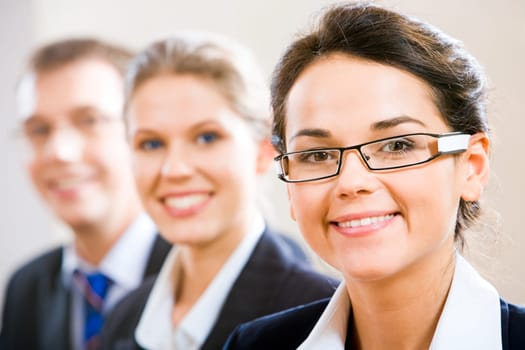 Row of business people with clever woman in front