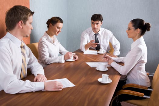 Group of young businessmen are discussing very important question