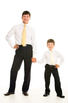 Portrait of smiling man and his son holding by hands over white background