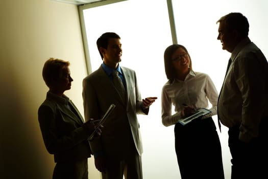 Portrait of business partners discussing or planning work at meeting