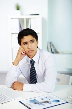 Portrait of a businessman thinking about new working ideas in office