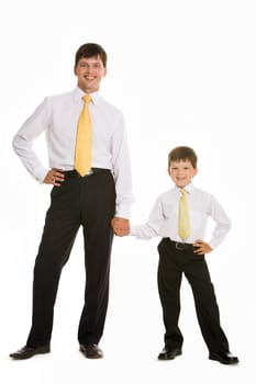 Portrait of smiling man and his son holding by hands over white background