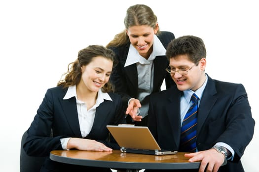 Portrait of confident business team gathered together at meeting and looking at the monitor of laptop with smiles