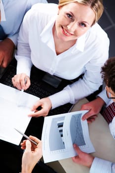 Above view of businesswoman looking at camera during negotiations