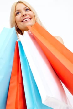 Photo of happy female with colorful shopping bags