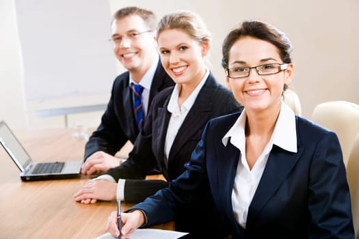 Group of three business people looking at camera