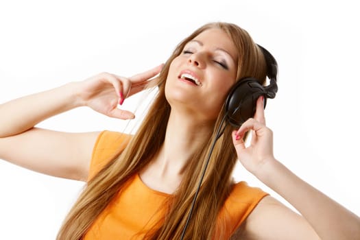 Close-up of pretty girl in headphones listening to music with pleasure