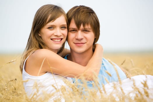 Image of handsome man and beautiful girl looking at camera